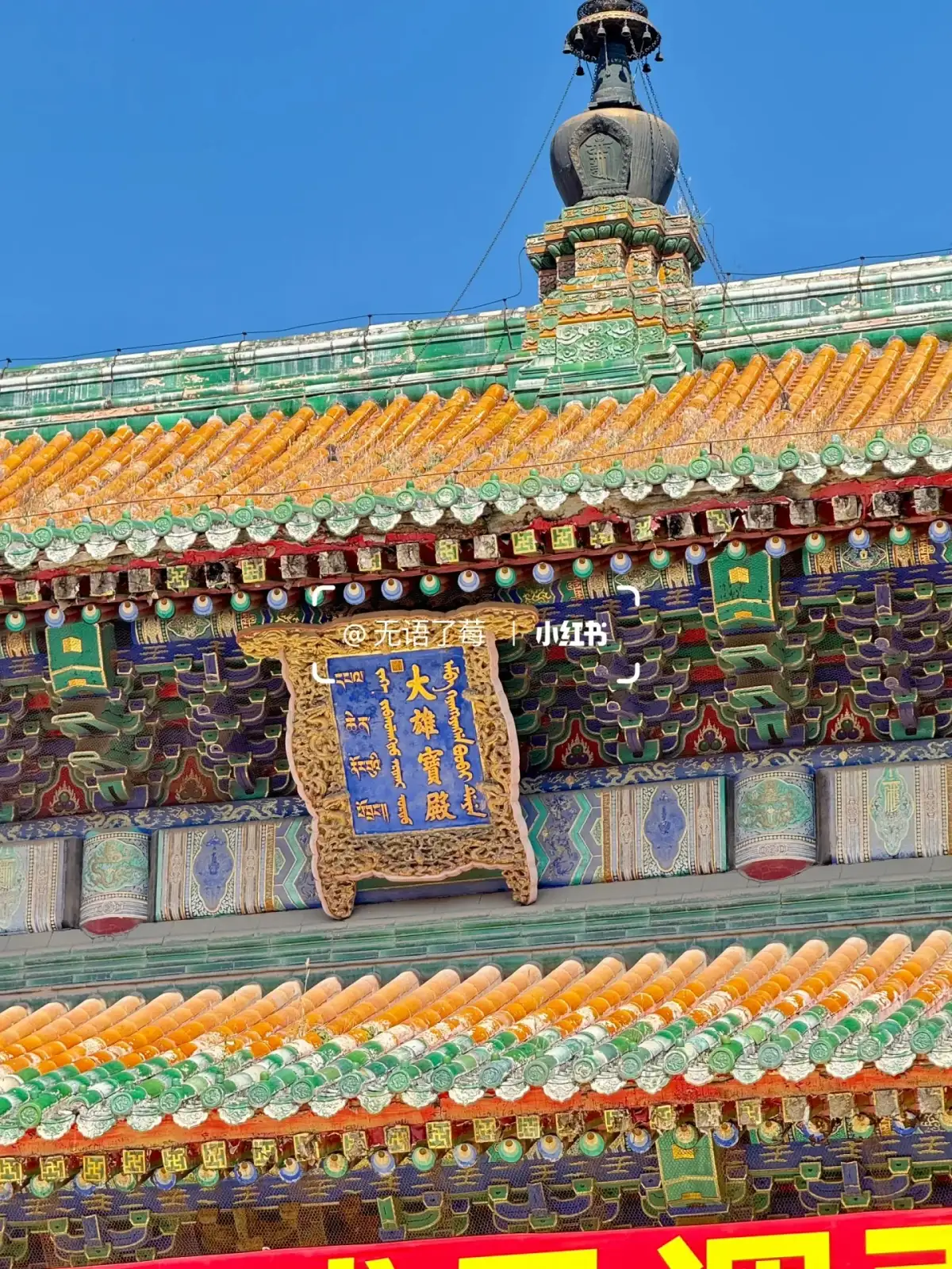 colorful glazed tile eaves, painted beam frames, and blue-background plaques