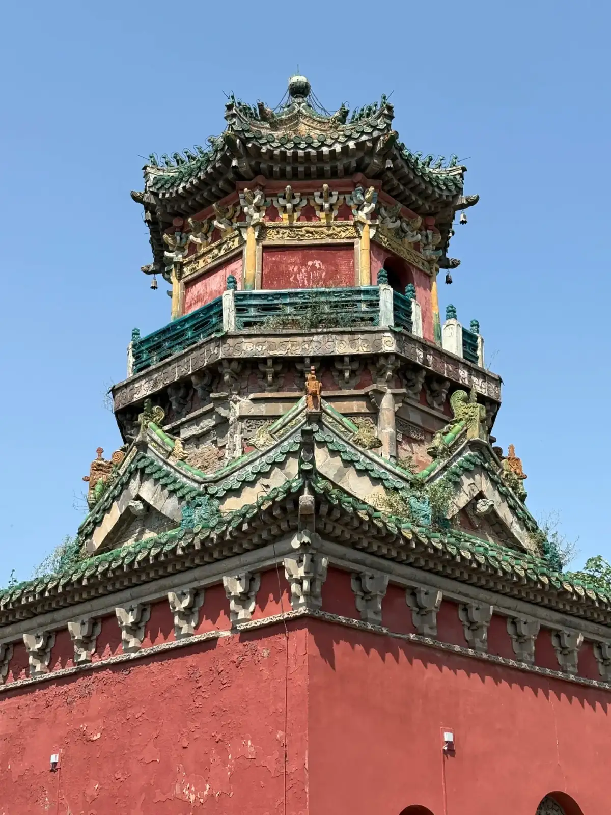 Close-up of the painted beams, railings, and eaves on the multi-story pavilion