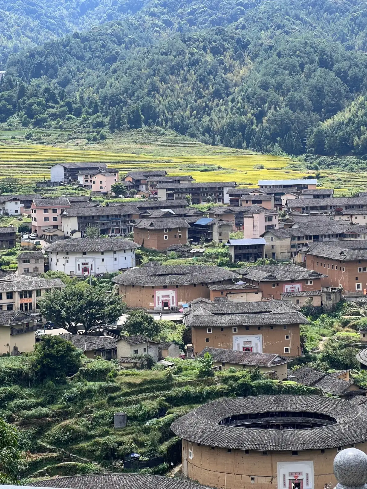 A distant view of the Chuxi Tulou Cluster in Fujian and the mountain village