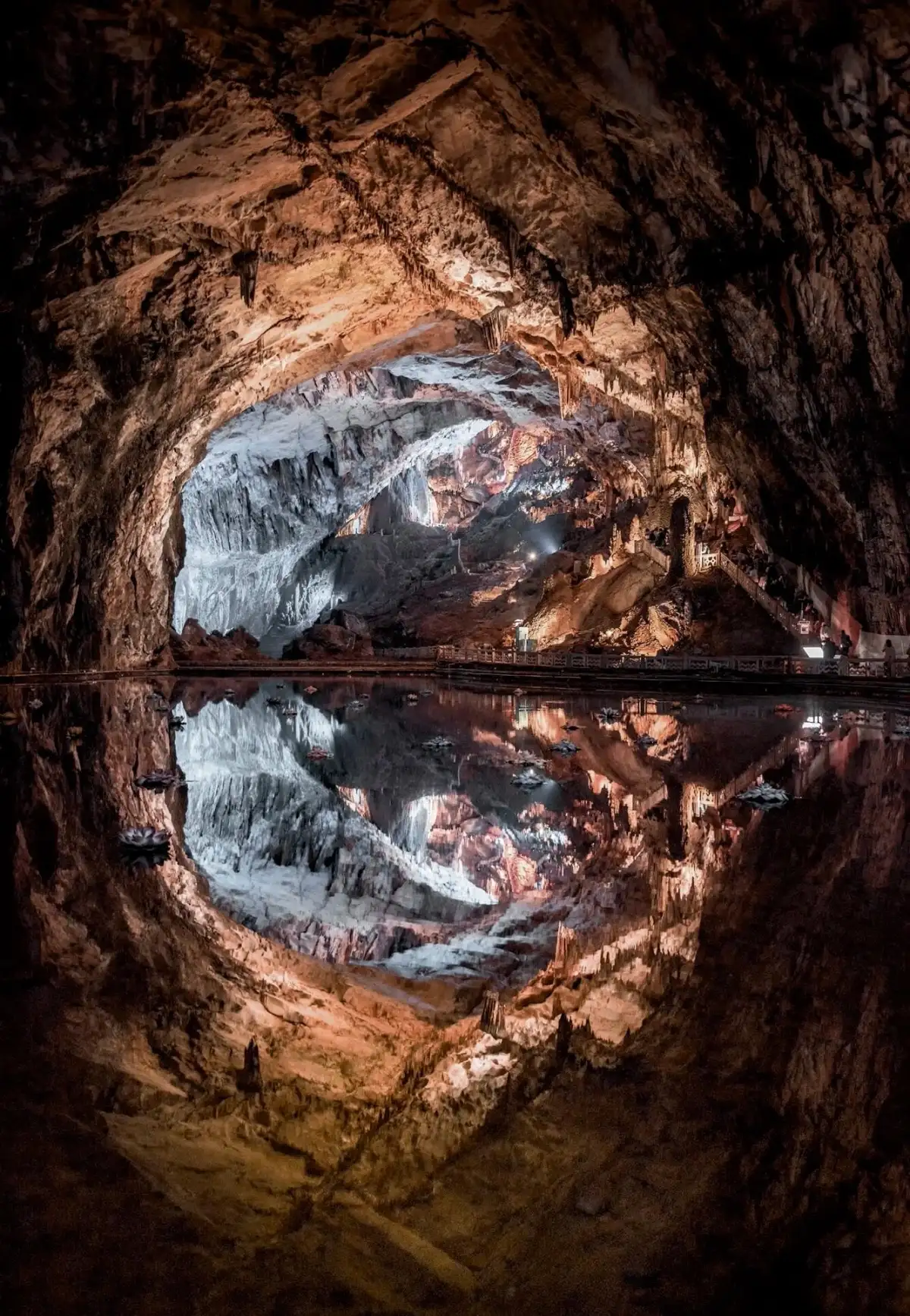 Arched caves and their symmetrical reflections in calm water