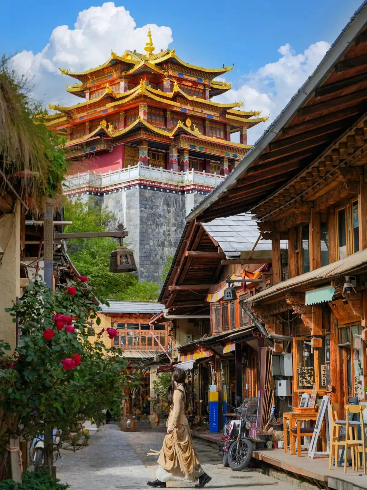 Wooden shops line the street, with buildings featuring golden-yellow roofs visible in the distance, and pedestrians walking sideways along the street.
