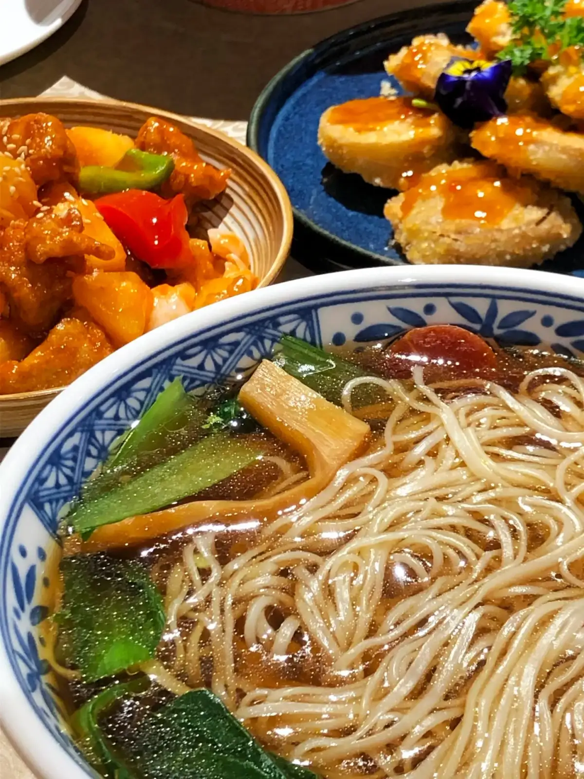 Close-ups of noodle soup and other dishes
