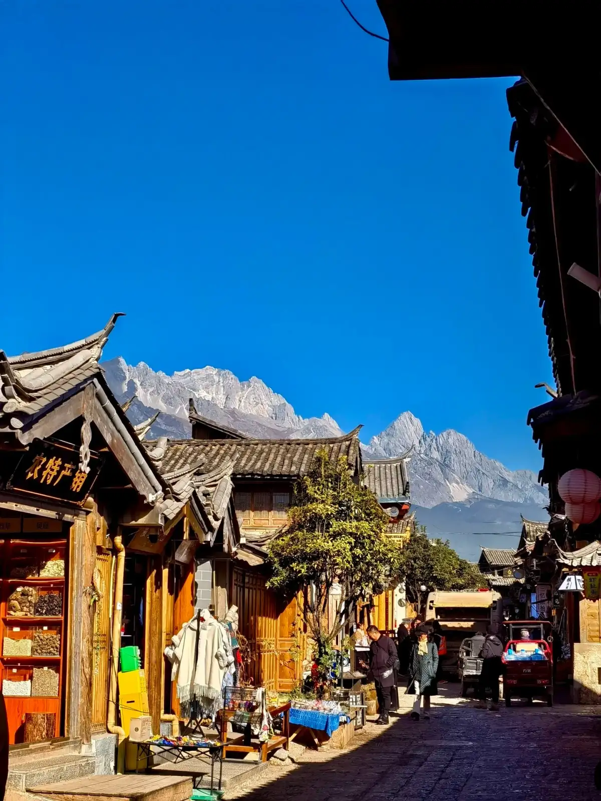 The streets and alleys of Baisha Ancient Town and the distant mountain peaks