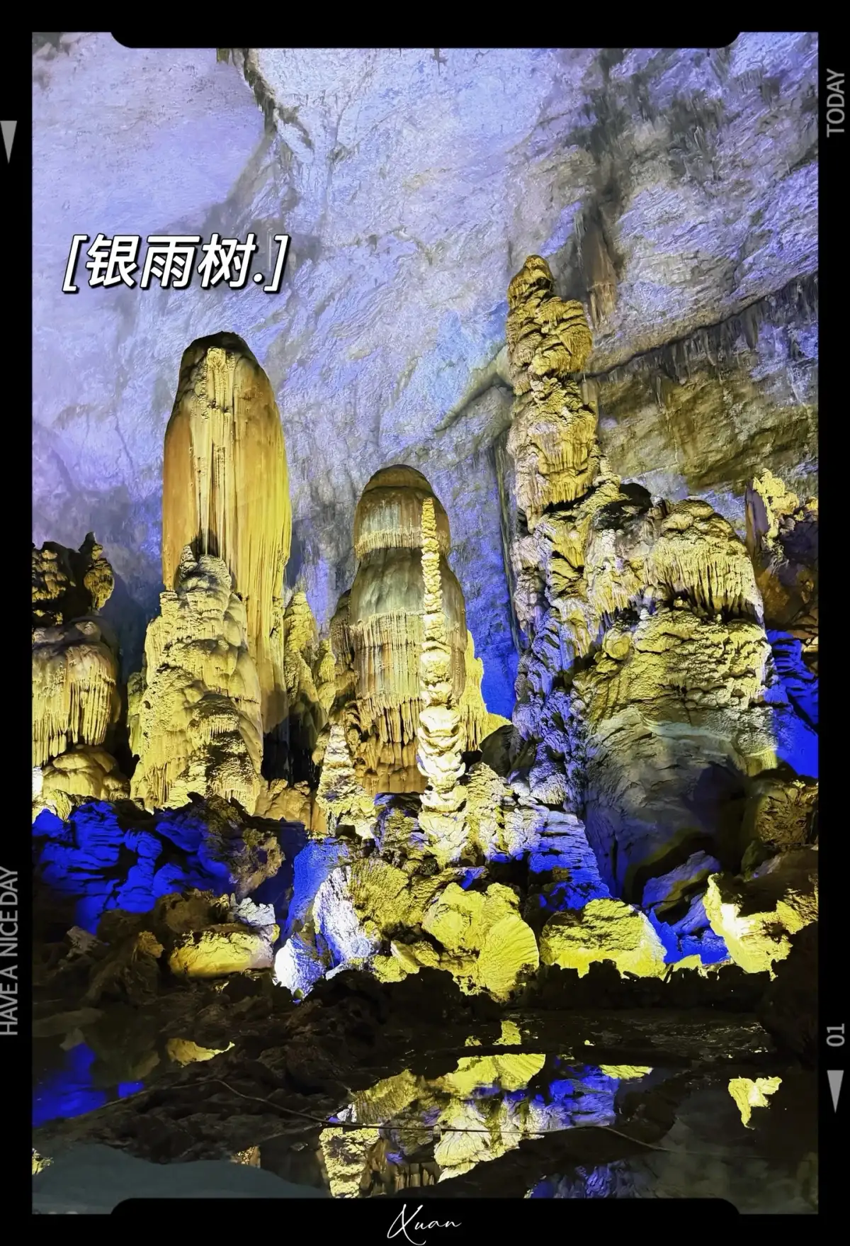 Clusters of slender sedimentary formations under cave lighting; the image features text by Yin Yushu