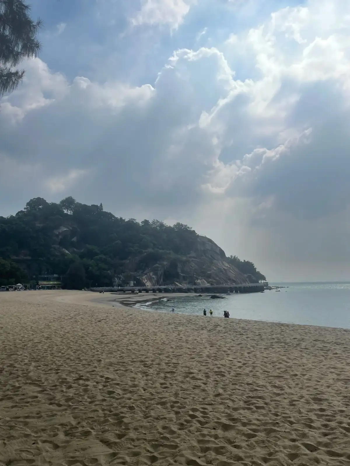 沙滩、海岸树林与远处游客