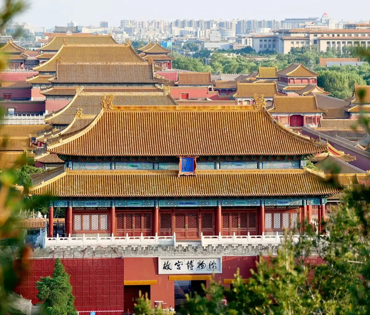 View of the Shenwu Gate of the Forbidden City and the layered yellow-tiled roofs behind it from Jingshan Hill