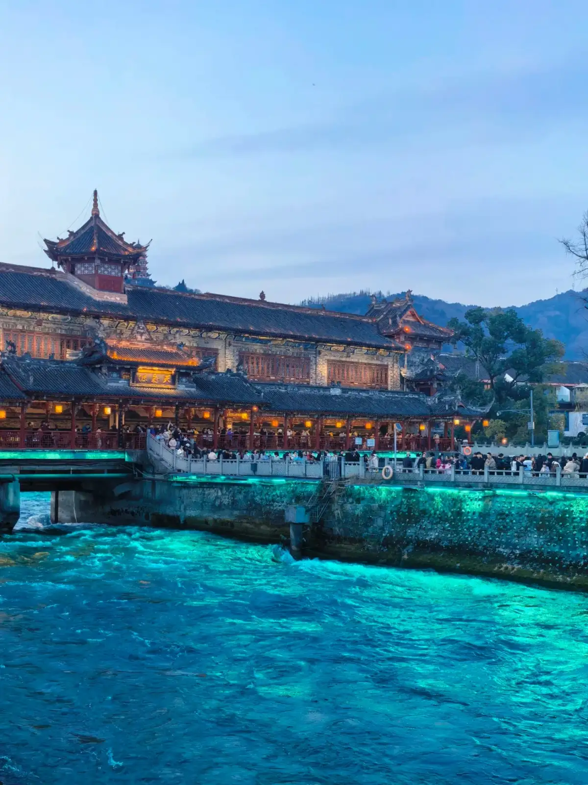 Night view of the South Bridge in Dujiangyan and the water surface
