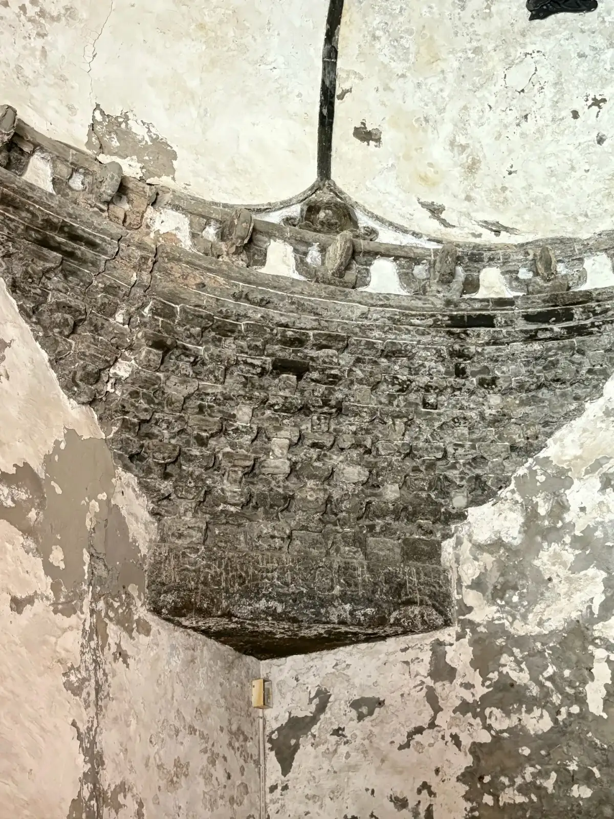 Weathered domes, brick walls, and interior carved structures