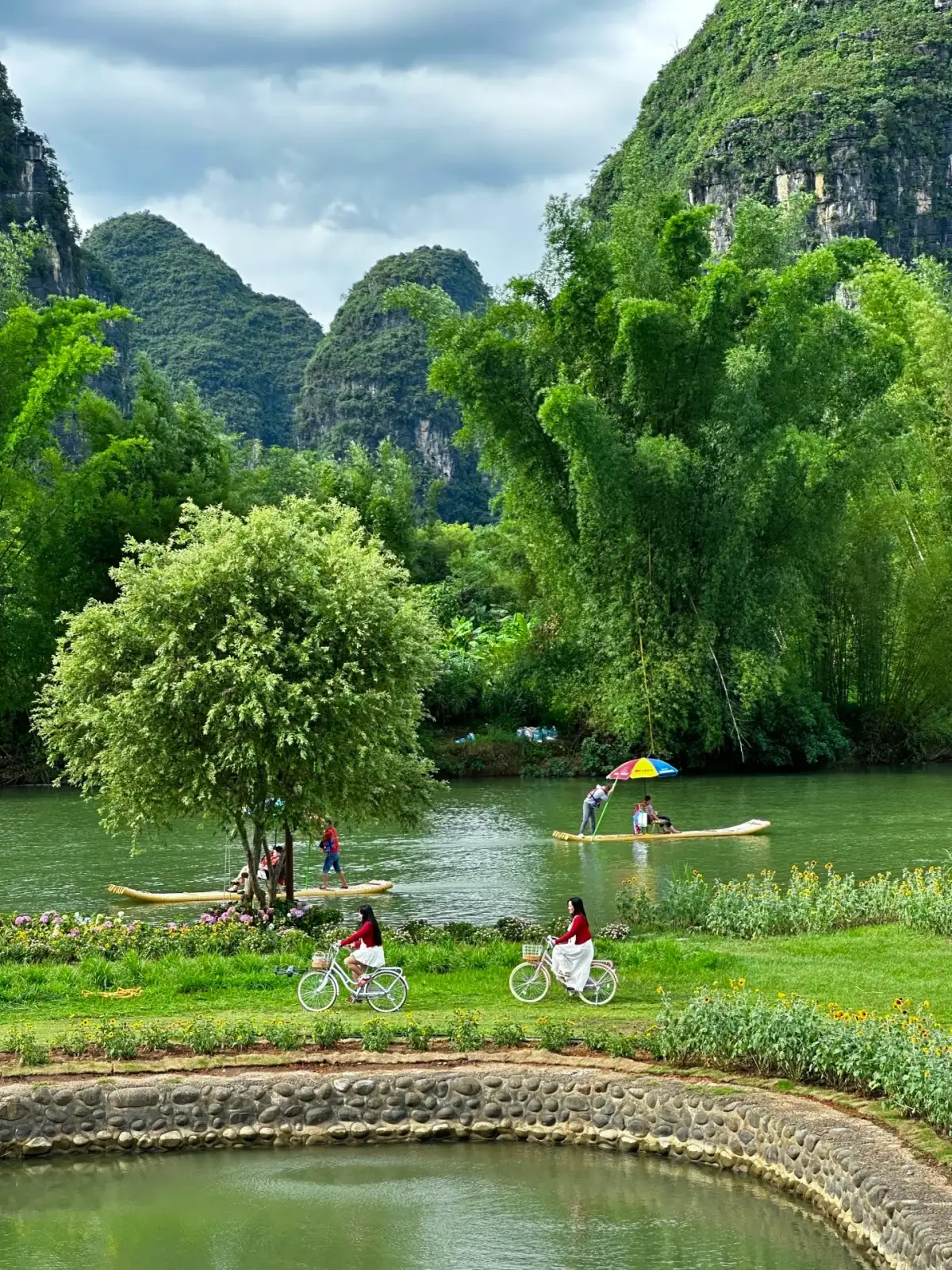 The Yulong River bank and cyclists in the distance