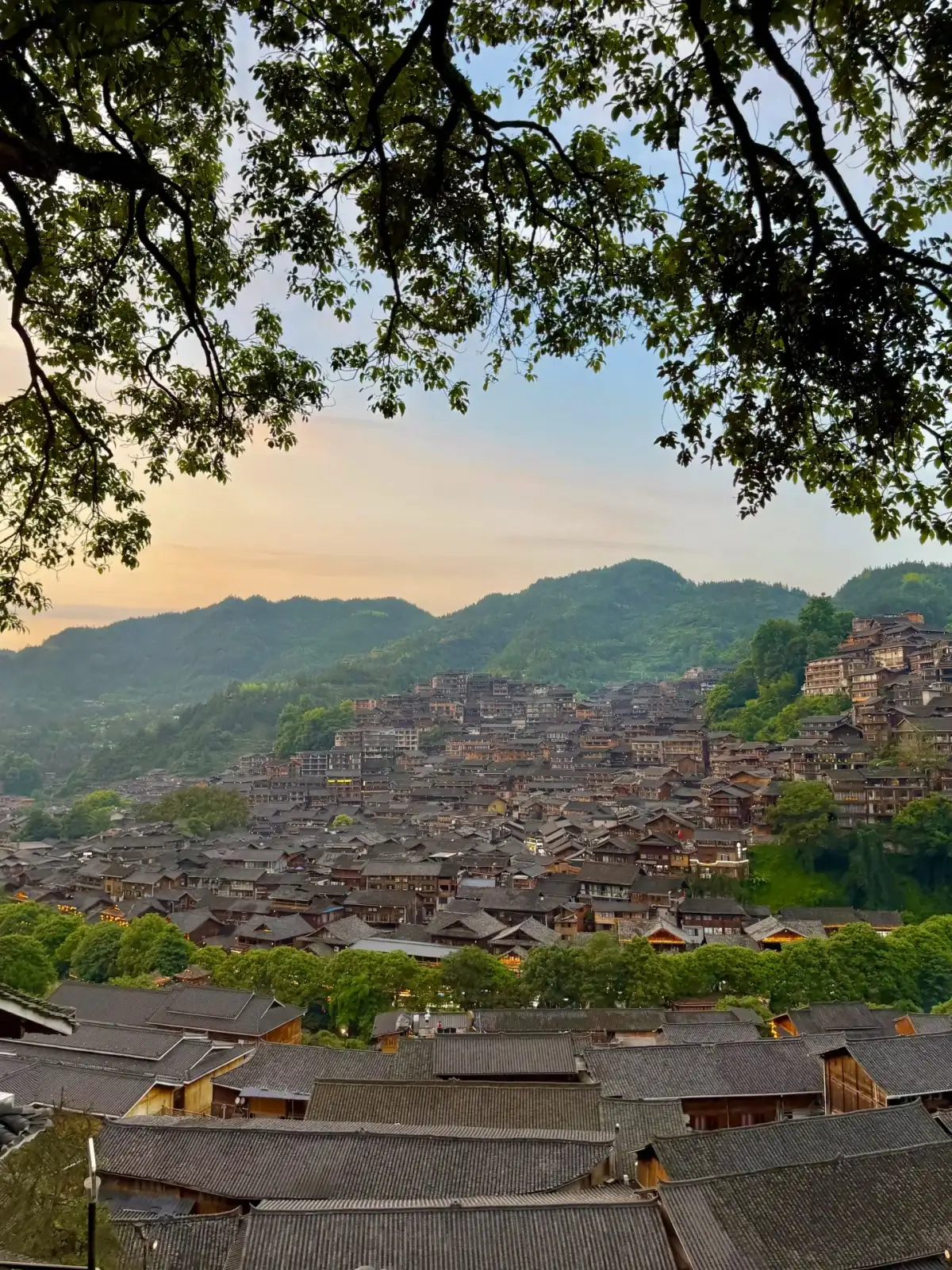 The rooftops of the wooden houses at Xijiang Qianhu Miao Village at dusk